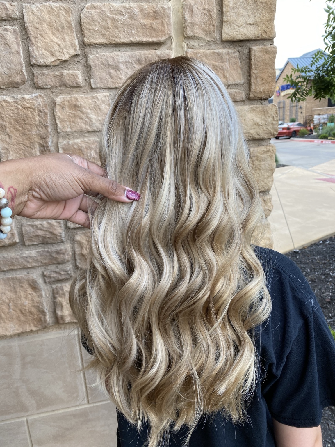 Long lived-in blonde balayage with dimensional waves